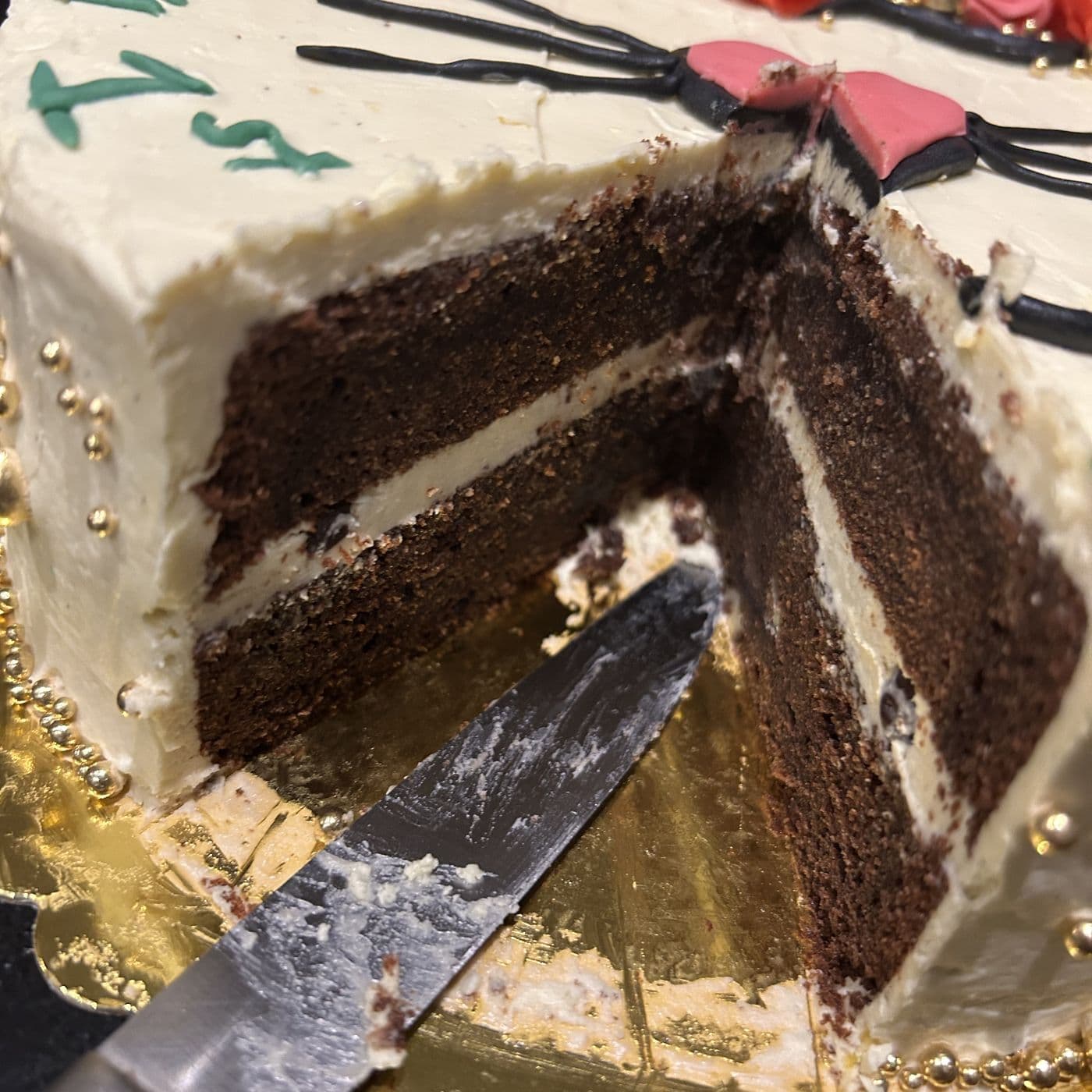 The same birthday cake cut open, showing layers of chocolate sponge and vanilla buttercream