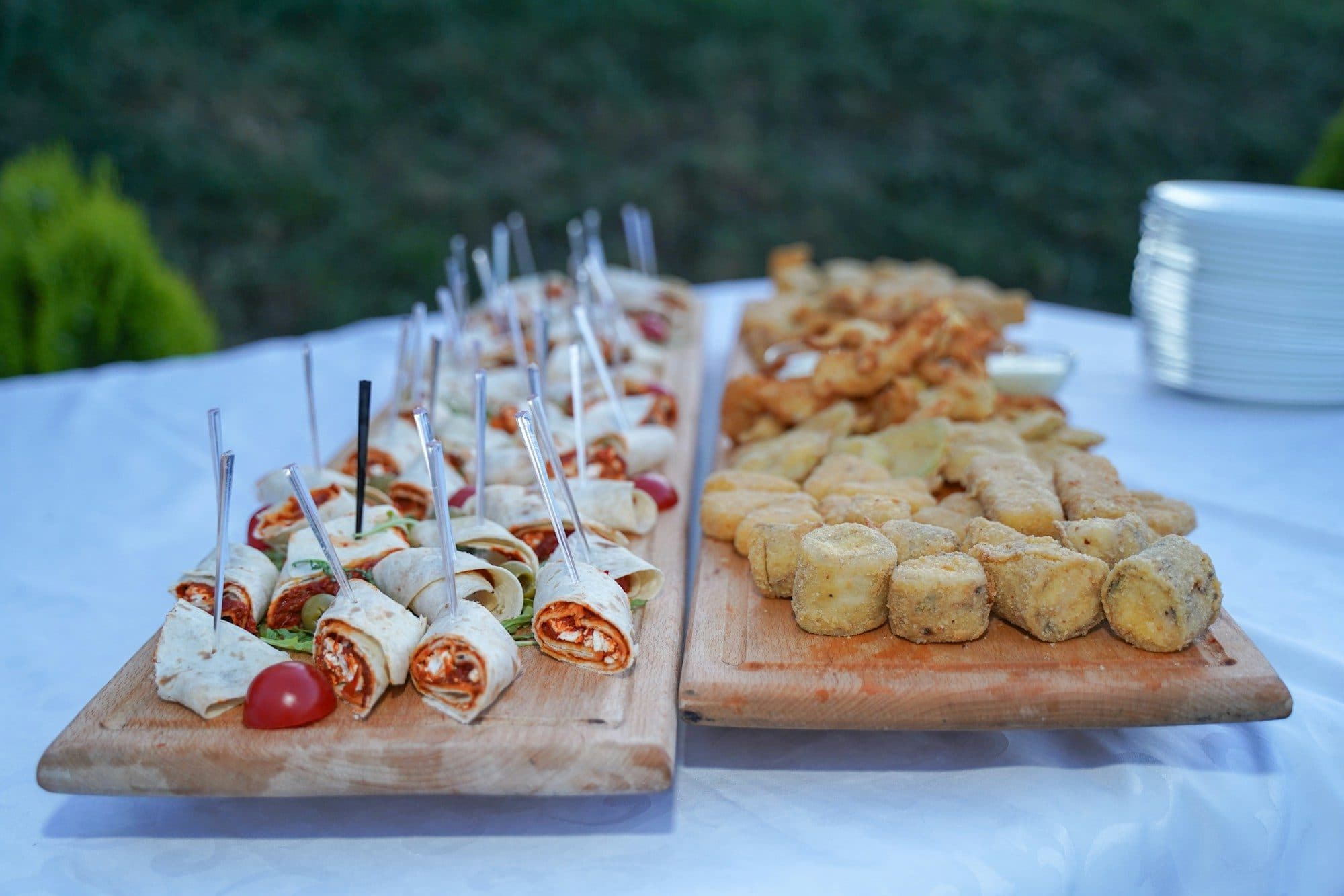 Boards of sliced wraps and savoury bites laid out on a party table