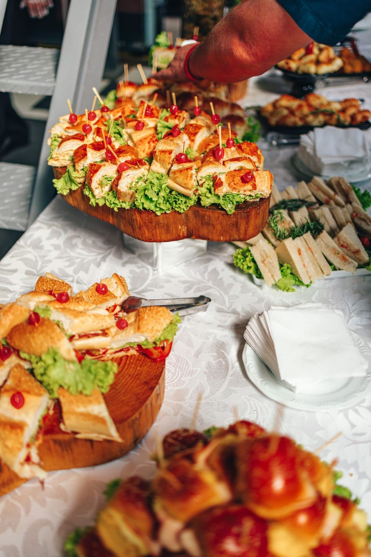 A buffet of sandwich platters, salads and savoury bakes set out for a party