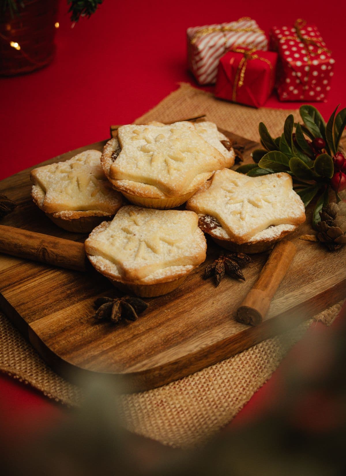 Mince pies with holiday spices on a wooden board